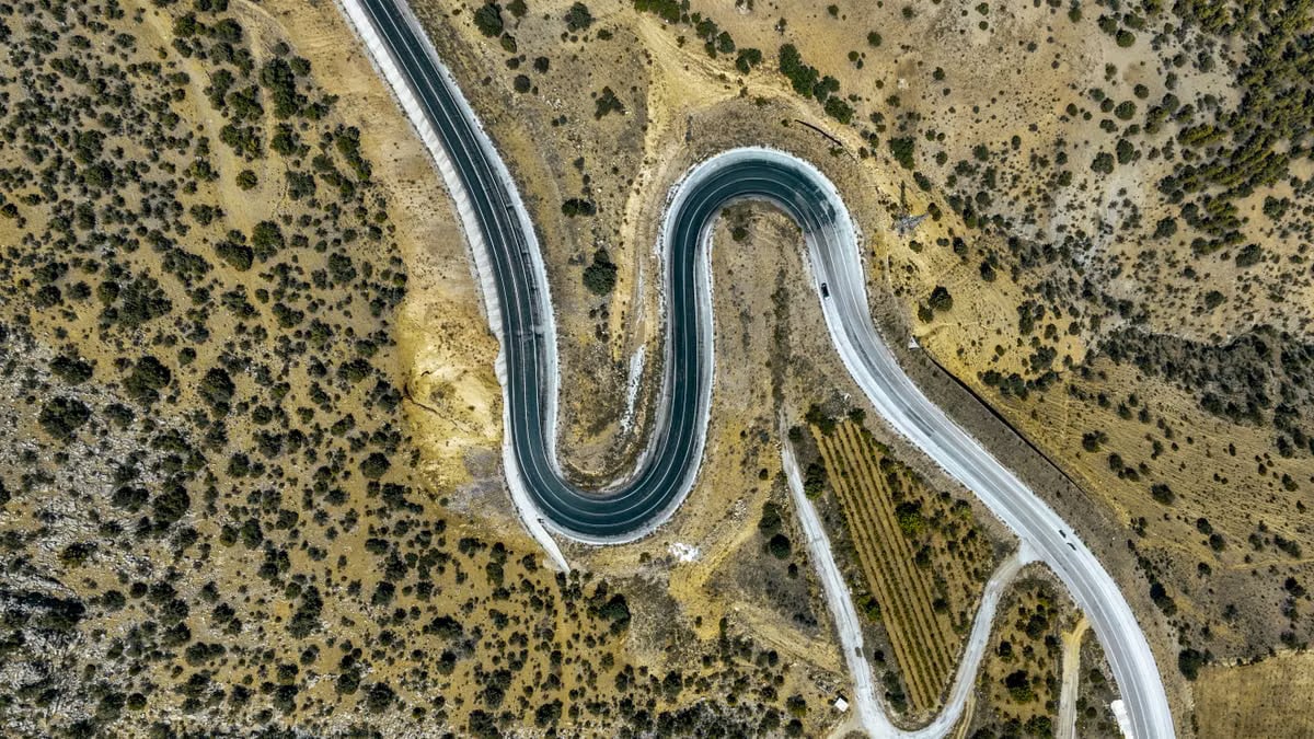 Stunning aerial view capturing a winding road through rugged terrain in Güneysınır, Türkiye.